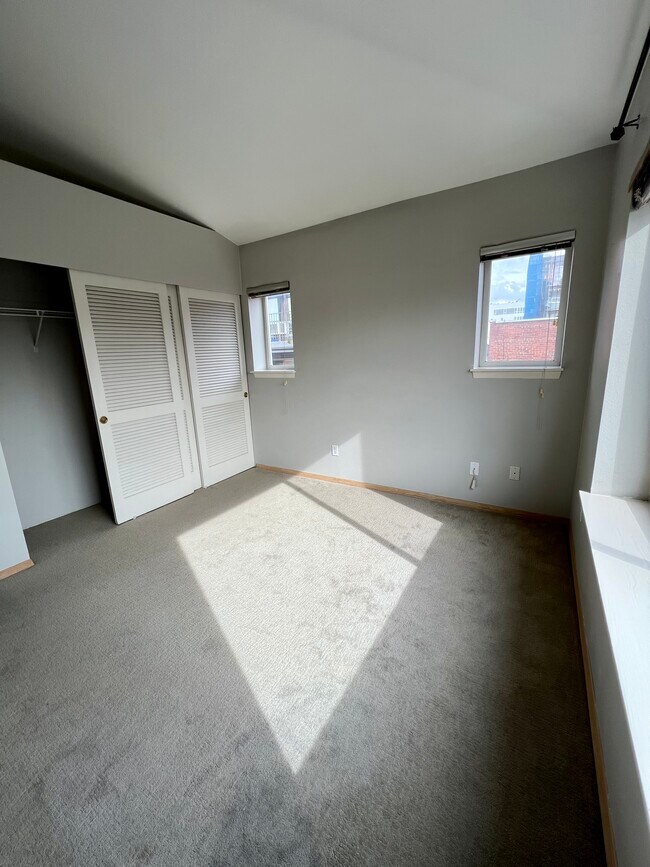 Bedroom 1 - wall to wall carpet and large closet - 712 E Denny Way