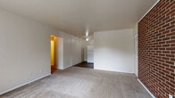 Located at 933 Wilmington Avenue in Dayton, Ohio, this one-bedroom, one-bathroom unit offers a practical and well-organized single-floor layout. The open living area is finished with neutral-toned carpet and bright white walls, creating a clean and welcoming atmosphere. A ceiling fan overhead provides year-round comfort, while the open sightline to the kitchen makes the space feel connected and functional.

The kitchen is equipped with white appliances, including a refrigerator, electric range, and an under-cabinet range hood. Warm wood-toned cabinetry lines the walls, offering ample storage, and the space is finished with durable wood-look vinyl plank flooring that adds a modern touch.

The bedroom is a comfortable, well-proportioned room with plush carpeting and baseboard heating. A full-width closet with bifold doors provides generous storage space, and the room is accessed through a classic six-panel door off the hallway.

The bathroom features a full tub-shower combo with a smooth surround, complemented by clean white fixtures including a standard tub and toilet — simple and easy to maintain.

A connecting hallway ties the rooms together efficiently, rounding out a thoughtfully arranged floor plan well-suited for everyday living.