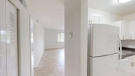 Located at 2450 S Park Rd in Pembroke Park, FL, this one-bedroom, one-bathroom unit offers a well-organized, single-level layout designed for comfortable everyday living. Light-colored tile flooring runs throughout the entire space, lending a clean and cohesive look that reflects natural light from the windows.

The living room is an open, airy space highlighted by a large window with vertical blinds that allow generous natural light and outdoor views. A pendant light fixture adds a modern accent. The clean white walls and neutral palette create a bright, welcoming atmosphere.

The bedroom is generously proportioned, featuring the same tile flooring and direct access to a dedicated closet — one of two closets in the unit — providing practical storage solutions. The room's simple, clean design allows for versatile furniture arrangements.

The kitchen is well-appointed with white shaker-style cabinetry, dark granite-look countertops, a subway tile backsplash, and stainless steel appliances including an over-the-range microwave and an electric range, offering a functional and stylish cooking space.

The bathroom includes a full tub-shower combination with white tile surround, maintaining the clean, minimal aesthetic found throughout the unit. An entrance area provides a smooth transition into the home. The overall ambiance is bright, tidy, and move-in ready.