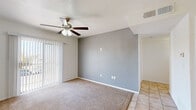 Located at 12121 Pellicano Dr in El Paso, TX, this one-bedroom, one-bathroom unit offers a practical and well-organized single-floor layout. The living room is a comfortable, carpeted space anchored by a ceiling fan with light fixture and a sliding glass door fitted with vertical blinds, allowing natural light to fill the room while providing access to an outdoor view. The flooring transitions from carpet in the living area to tile near the entryway and kitchen.

The kitchen is fully equipped and features warm-toned wooden cabinetry extending along two walls, dark granite-style countertops, tile flooring, and a full suite of white appliances including a refrigerator, electric range, and dishwasher. Overhead fluorescent lighting keeps the space bright and functional.

The bedroom is a quiet, carpeted room with a window fitted with blinds, offering natural light and a sense of openness. It includes access to a spacious walk-in closet with dual hanging rods and shelving on both sides, providing ample storage.

The bathroom features a tub and shower combination with full-height marble-style tile surround, tile flooring, a wooden medicine cabinet, and a vanity with countertop space. Clean finishes throughout give the bathroom a tidy, well-maintained appearance.
