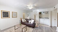 This well-organized 2-bedroom, 2-bathroom single-floor residence at 400 Hayden Rd in Tallahassee, Florida offers a practical and comfortable layout throughout. The living room features wood-look flooring, a ceiling fan, and an open feel that connects seamlessly to the rest of the home. A dedicated in-unit laundry area is conveniently accessible from the living space. The dining room is bathed in natural light from a large sliding glass door with vertical blinds that frame a lush outdoor view, creating an inviting atmosphere for everyday meals. The kitchen features light wood cabinetry, ample counter space on both sides, and a clean, functional galley-style layout. Both bedrooms offer ceiling fans, wood-look flooring, and well-sized closets—one bedroom includes a walk-in closet, while the primary bedroom provides a comfortable, serene retreat. The two bathrooms are straightforward and functional, each with a shower-tub combination. A welcoming entryway with light-toned walls and hard-surface flooring ties the home together. The consistent use of neutral tones and wood-look flooring throughout creates a cohesive, clean aesthetic across the entire residence.