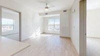 Located at 919 Alcott St in Denver's vibrant 80204 corridor, this modern two-bedroom, two-bathroom residence offers a thoughtfully designed single-level layout. The open-concept living, dining, and kitchen area serves as the heart of the home, filled with natural light streaming through a large window that frames city views. A ceiling fan adds comfort to the bright, airy living space.

The kitchen is well-appointed with floor-to-ceiling gray shaker-style cabinetry, a full suite of stainless steel appliances including a refrigerator with ice maker, electric range, over-the-range microwave, and dishwasher. A peninsula with a built-in sink provides additional prep space and casual dining potential. Light wood-style flooring flows throughout the main living areas, lending a clean, contemporary feel.

The primary bedroom is generously sized and features a spacious walk-in closet with built-in shelving and hanging rods. The second bedroom includes a sliding-door closet and plush carpet flooring. Both bathrooms are finished in a crisp, neutral palette — one with a full soaking tub and tiled surround, and the other with a vanity featuring a large mirror. Three closets total ensure ample storage throughout the residence.