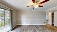 Located at 2409 Meadowbrook Avenue in New Bern, North Carolina, this single-story, three-bedroom, one-bathroom home offers a practical and well-appointed layout. Throughout the home, wood-look luxury vinyl plank flooring adds warmth and continuity, complemented by crisp white crown molding and neutral warm-beige walls that create a clean, cohesive aesthetic.

The kitchen is a functional centerpiece, featuring gray shaker-style cabinetry, light countertops, and black appliances including a range, dishwasher, and refrigerator. Natural light flows in through a window near the entrance, brightening the space.

The primary bedroom is generously sized and includes a ceiling fan with light fixture and a dedicated closet area with laundry hookups — a convenient feature for everyday living. The two additional bedrooms each offer closet storage, natural light from windows with blinds, and the same consistent flooring found throughout the home. Crown molding adds a refined touch to each room.

The bathroom features a full tub-shower combination with white tile surround. A central hallway connects the bedrooms to the main living areas, supporting an efficient and functional flow throughout this well-maintained home.