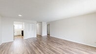 Located at 4061 Eagle Roost Dr in Indianapolis, IN, this single-story, 2-bedroom, 1-bathroom home offers a practical and well-organized layout. The combined living and dining area is a bright, open space featuring wood-look laminate flooring, neutral white walls, and a textured ceiling. A sliding glass door allows natural light to fill the room and provides access to an outdoor area. The kitchen is outfitted with white shaker-style cabinetry, light countertops, a stainless steel refrigerator, and a stainless steel dishwasher, presenting a clean and functional cooking space. Both bedrooms are carpeted and feature windows with blinds that allow natural light; the primary bedroom is notably spacious with multiple closet options. The full bathroom includes a combined tub and shower, a single-sink vanity with white cabinetry, and wood-look tile flooring. A dedicated laundry room accommodates a full-size washer and dryer with wire shelving above. Multiple hallway closets provide generous storage throughout. The home's consistent neutral palette and updated finishes create a cohesive, move-in-ready environment.