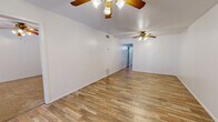 This single-story, 2-bedroom, 2-bathroom home features a thoughtfully organized floor plan that maximizes functionality throughout. The living room is bright and open, showcasing durable wood-look flooring, a textured ceiling, and a ceiling fan with light fixture. A set of glass-paned French doors along with a side window invites natural light and provides an inviting entry point to the space.

The combined kitchen and dining area is efficiently designed, featuring white cabinetry with brushed hardware, light-toned countertops, terracotta tile flooring, and a full suite of appliances including an electric range and dishwasher. The layout allows for easy flow between cooking and dining.

Both bedrooms are generously proportioned and finished with plush wall-to-wall carpeting and ceiling fans. The spacious primary bedroom comfortably accommodates large furnishings and connects to ample closet space, including a walk-in closet with dual hanging rods and built-in shelving.

Each bathroom mirrors the kitchen's terracotta tile flooring and features dual-sink vanities with wide mirrors, under-sink storage, and a tub-shower combination. A dedicated utility room and additional hallway closets provide practical storage solutions throughout. The home's clean, neutral palette and consistent finishes create a cohesive and move-in ready environment.