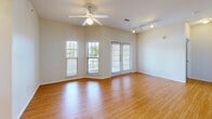 Located at 14220 S Wayside Dr in Houston, TX, this single-story, 2-bedroom, 2-bathroom home offers a comfortable and functional layout. Warm hardwood flooring flows consistently throughout the entire home, creating a cohesive and inviting atmosphere.

The open living area is a standout feature, bathed in natural light from multiple windows and a set of French doors that open to the outdoors. A ceiling fan with light fixture and track lighting add to the room's versatility and comfort.

The kitchen is well-appointed with warm wood cabinetry, a gas range, a full-size refrigerator, and ample counter space, connecting conveniently to the entry hallway.

Both bedrooms are generously sized, each equipped with a ceiling fan and windows that bring in natural light. The primary bedroom includes access to a spacious walk-in closet with wire shelving, as well as an en-suite bathroom featuring a double-sink vanity with wood cabinetry, a shower/tub combination with accessibility grab bars, and built-in shelving. The second bathroom also includes a tub/shower combo with accessibility features and a single-sink vanity. An additional closet with wire shelving and in-unit laundry hookups provides practical storage solutions.
