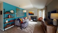 This single-floor residence in Tacoma, WA offers a well-designed layout across several thoughtfully appointed spaces. The living room serves as a focal point, featuring a vaulted ceiling, a tile-surround fireplace, and generous natural light streaming through large windows. The kitchen is outfitted with dark espresso cabinetry, stainless steel appliances including a refrigerator and range, light countertops, and durable wood-look flooring, creating a functional yet stylish cooking space. Adjacent to the kitchen, the dining area accommodates a full-sized table and benefits from window views, with a ceiling fan overhead adding comfort. The primary bedroom includes plush carpet, a walk-in closet with rod storage, and a window for natural light. A second bedroom offers similar carpeted comfort and its own window. Two bathrooms mirror the kitchen's design aesthetic, each featuring dark vanity cabinetry, white countertops, framed mirrors, and wood-look flooring. One bathroom includes a walk-in closet with mirrored sliding doors. A dedicated laundry closet with an in-unit washer provides added convenience. Throughout, neutral wall tones and consistent finishes contribute to a cohesive, move-in-ready atmosphere.