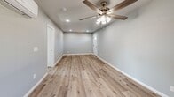 Located at 4040 E Dakota Ave in Fresno, CA, this efficiently designed 2-bedroom, 2-bathroom single-story unit offers a clean, modern aesthetic throughout. The open-concept layout seamlessly connects the kitchen and living area, creating a bright and functional shared space. Light wood-look flooring runs throughout the unit, complementing the soft gray walls and crisp white trim for a cohesive, contemporary feel. Ceiling fans provide added comfort in both the living area and bedrooms.

The kitchen is well-appointed with white shaker-style cabinetry, dark countertops, a stainless steel sink, and a full suite of stainless steel appliances including a refrigerator, range, and over-the-range microwave. Recessed lighting illuminates the space effectively.

Both bedrooms are comfortably sized, featuring light-filled windows with curtains, light wood flooring, ceiling fans, and wall-mounted mini-split HVAC units for individual climate control. Three closets are distributed throughout the unit for ample storage.

The bathrooms are a standout feature, showcasing elegant marble-style porcelain tile in the walk-in glass-enclosed shower, accented by a decorative mosaic tile border. The clean white vanity and chrome fixtures complete the polished, upscale bathroom design. This unit offers a thoughtfully updated living environment with quality finishes throughout.