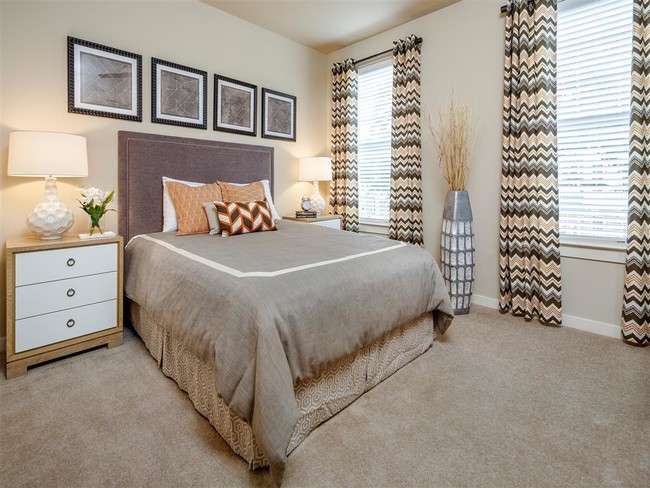 Bedroom with two windows and plush carpeting - Thirty Oaks