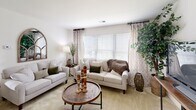 Located at 2113 Bromley Park Dr in Winston-Salem, NC, this single-floor residence offers a well-organized layout designed for comfortable everyday living. The living room serves as the heart of the home, featuring large windows with blinds and decorative curtains that invite generous natural light and offer views of the surrounding greenery, creating a warm and inviting atmosphere. The kitchen is highlighted by white cabinetry, a peninsula with a white countertop, and a breakfast bar with seating for two — ideal for casual dining or morning coffee. Adjacent to the kitchen, a dedicated dining nook provides an intimate setting for meals, complete with wall decor that adds a homey character. The primary bedroom is spacious and well-lit, featuring plush carpeting, a closet, and a window with outdoor views. A second bedroom offers similar comfort with soft carpet flooring and a window that allows natural light to filter in. The bathroom is clean and functional, featuring a mirrored medicine cabinet and crisp white fixtures. Throughout the home, a neutral color palette of soft whites and warm beiges creates a cohesive and calming aesthetic, while tile flooring at the entry transitions smoothly into carpeted living spaces.