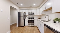 Located at 38350 Crossbrook Ave in Willoughby, Ohio, this two-floor residence offers a well-appointed layout with modern finishes and a cohesive neutral color palette throughout. The main level features warm hardwood-style flooring that flows through the living and dining areas, complemented by a fully equipped kitchen outfitted with white shaker cabinetry, white quartz countertops, stainless steel appliances including a refrigerator, electric range, microwave, and dishwasher, and recessed lighting overhead. A secondary kitchenette area with its own sink, cabinetry, and stainless steel dishwasher provides added functionality. Bathrooms on both levels feature white vanities with clean quartz surfaces, framed mirrors, and light hardwood-style flooring. One bathroom includes a shower/tub combination, while another is designed with accessibility grab bars. Carpeted bedrooms offer a comfortable, quiet retreat, with windows allowing natural light and views of the surrounding area. A carpeted staircase with white trim connects the two floors. Additional rooms with plush carpet and neutral walls provide versatile living spaces. The overall ambiance is clean, bright, and move-in ready, with a consistent modern design sensibility carried throughout the entire home.