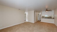 Located at 4001 S Watt Ave in Sacramento, CA, this single-floor unit offers three bedrooms and two bathrooms thoughtfully arranged across a compact yet functional layout. The open living room greets you with warm beige carpeting, a tile-surround fireplace, and a sliding glass door covered by vertical blinds that allows natural light to fill the space. Built-in shelving along a central dividing wall adds convenient storage and visual character to the common area.

The kitchen is efficiently designed with white shaker cabinetry, granite countertops, stainless steel appliances including a range, microwave, and dishwasher, wood-look flooring, and a window for added brightness. A stacked washer and dryer unit is conveniently tucked into a dedicated closet just off the kitchen.

The bathrooms feature granite-topped vanities with white cabinetry, large mirrors, and wood-look flooring. The bedrooms are carpeted and dressed in neutral tones, with the primary bedroom offering a reach-in closet. Additional bedrooms include window treatments that provide natural light and privacy. A hallway connects the rooms, complemented by a dedicated closet for extra storage. The overall aesthetic is clean, neutral, and move-in ready.
