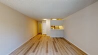 Located at 3500 Granada Avenue in Santa Clara, California, this 540-square-foot, one-bedroom, two-bathroom apartment offers a functional and well-appointed single-floor layout. Throughout the unit, light wood-style laminate flooring provides a clean, cohesive look, complemented by textured popcorn ceilings and neutral warm-toned walls.

The living room is bright and open, featuring a sliding glass door that leads to a private balcony, allowing natural light to fill the space. A wall-mounted AC unit and baseboard heating offer year-round climate control. The adjacent galley-style kitchen is efficiently designed with light wood cabinetry, white countertops, a stainless steel sink, and appliances including a refrigerator, stove, and dishwasher.

The primary bedroom spans 140 square feet and includes a built-in sliding door closet, providing ample storage. Both bathrooms feature light wood cabinetry with white countertops, and one includes a full tub-shower combination with white tile surround and chrome fixtures. A hallway connecting the bedroom and bathrooms adds to the unit's practical flow, with additional closet space visible along the corridor.