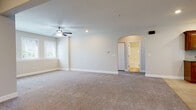 Located at 20 Saint Ivans Circle in Bloomington, Illinois, this single-story home offers a thoughtfully designed layout finished in warm, neutral tones throughout. Soft beige walls and plush carpeting create a cohesive, comfortable atmosphere across the bedrooms and living areas, while tile flooring anchors the kitchen, bathrooms, and laundry room.

The kitchen is a functional highlight, featuring rich wood cabinetry, dark granite countertops, a tile backsplash, recessed lighting, and stainless steel appliances. A peninsula provides added counter space and separates the kitchen from adjacent living areas.

Multiple carpeted bedrooms offer natural light through blinds-fitted windows, with ceiling fans providing comfort overhead. One bedroom connects directly to an en-suite bathroom featuring a soaking tub with tile surround, a separate glass-enclosed shower, and tile flooring — a refined and relaxing retreat.

A dedicated laundry room includes a full-size washer and dryer, tile flooring, double sliding doors for additional storage, and an electrical panel, combining practicality with organization. One of the larger living areas features an elegant arched doorway, adding a subtle architectural detail. The overall design is clean, functional, and move-in ready.