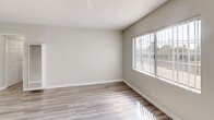 This 640 square foot apartment in Los Angeles offers a thoughtful layout maximizing its compact footprint. The single-story unit features one bedroom and one bathroom, ideal for individuals or couples seeking an efficient living space.

The heart of the home is an open-concept kitchen and living area. The kitchen boasts sleek white cabinetry, a marble-look countertop, and a practical breakfast bar, seamlessly integrating with the living space. Modern appliances and ample storage enhance functionality.

The bedroom, measuring 160 square feet, provides a cozy retreat with large windows allowing natural light to flood the space. Light-toned wood-look flooring runs throughout, creating a cohesive and contemporary aesthetic.

The bathroom features a combination tub-shower with neutral tiling and a built-in niche for added convenience. A window above the shower introduces natural light while maintaining privacy.

Throughout the apartment, large windows with vertical blinds offer views of the surrounding area and fill the space with sunlight. The neutral color palette, predominantly whites and light grays, contributes to a bright and airy ambiance.

Thoughtful details like recessed lighting and a ceiling fan in the living area add both style and comfort. The apartment's layout, with two hallways, ensures easy flow between rooms, making the most of the available space.