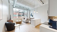 Located at 628 Ellicott St in Buffalo, NY, this 1-bedroom, 1-bathroom loft-style unit blends industrial character with modern finishes throughout. The open-concept living, dining, and kitchen area serves as the heart of the space, showcasing soaring ceilings with exposed spiral ductwork, track lighting, and oversized black-framed windows that flood the room with natural light and offer views of the surrounding urban streetscape. Light hardwood flooring runs throughout, enhancing the airy, contemporary feel. The kitchen features white cabinetry, a subway tile backsplash, quartz countertops, a center island with seating, stainless steel appliances, and globe pendant lighting. The bedroom offers elevated ceilings with clerestory windows, two closets with paneled doors, and a calm, neutral palette. The bathroom is finished with large-format marble-look tile, a frameless sliding glass shower enclosure with a built-in niche, and a clean white vanity. Additional conveniences include a dedicated laundry area, a hallway with built-in shelving, and two closets providing ample storage. This thoughtfully designed space delivers an urban loft aesthetic with refined, contemporary comfort in the heart of Buffalo.