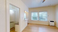 Located at 463 Hartford Avenue in Los Angeles, CA, this unit offers a smartly organized single-floor layout that makes efficient use of its space. Light wood-plank flooring runs throughout, lending warmth and visual continuity to every room.

The open living area is bright and airy, with large windows that invite natural light and offer views of the surrounding exterior. A ceiling fan adds comfort, while clean white walls keep the atmosphere fresh and neutral.

The kitchen is thoughtfully appointed with warm honey-toned wood cabinetry, a stainless steel refrigerator, a gas range, and light stone countertops. A pass-through counter connects the kitchen to the living space, enhancing the open feel. A window above the sink brings in additional natural light.

The unit includes two bathrooms, one of which features a full bathtub and shower combination finished with elegant marble-style large-format wall tiles accented by a mosaic border strip. Brushed nickel fixtures and wood-look tile flooring complete the refined look.

A separate bedroom area provides a quiet retreat, equipped with a ceiling fan and light fixture, and finished with the same consistent wood flooring found throughout the unit. The overall design is clean, functional, and well-suited for urban living in the heart of Los Angeles.