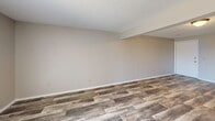 This 700 square foot apartment in Wichita, Kansas offers a well-designed living space with two bedrooms and one bathroom. The property features a thoughtful layout, maximizing its single-floor plan. The primary bedroom, measuring 140 square feet, provides ample space for comfortable living.

The interior showcases a blend of modern updates and practical design. The living areas boast newly installed wood-look flooring, adding warmth and durability to the space. In contrast, the bedrooms are carpeted, offering a cozy underfoot feel. Ceiling fans are present in multiple rooms, enhancing air circulation and comfort.

The kitchen is a highlight, featuring wooden cabinetry that adds a touch of traditional charm. It comes equipped with modern appliances, including a dishwasher, ensuring convenience for daily tasks. The bathroom, while not extensively detailed, appears to have a standard tub-shower combination with white fixtures.

Large windows in the living area and bedrooms allow for natural light to flood the space, creating a bright and airy atmosphere. Mirrored closet doors in one area add depth and functionality. The textured ceilings throughout maintain a cohesive look across the apartment.

This compact yet well-appointed apartment offers a balanced mix of comfort and practicality, ideal for those seeking an efficient living space in Wichita.