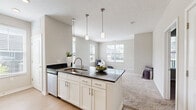 Located at 5300 Oak Passage Dr in Columbus, Ohio, this single-floor, one-bedroom, one-bathroom residence offers a thoughtfully designed layout that maximizes every square foot of living space. The kitchen is a standout feature, showcasing crisp white cabinetry, dark granite countertops, a white subway tile backsplash, and a full suite of stainless steel appliances including a range, microwave, and refrigerator. A peninsula with pendant lighting overhead creates a natural divide between the kitchen and living area, adding both style and function. Light wood-look flooring runs throughout the kitchen, lending a clean, contemporary feel. The bedroom is a comfortable retreat, featuring soft wall-to-wall carpeting, neutral gray walls, and a window with blinds that allows natural light to filter in. A dedicated closet provides convenient storage. The bathroom is well-equipped with white cabinetry, dark countertops with a single undermount sink, brushed nickel hardware, a mirror, and a separate shower. Wood-look flooring continues in the bathroom for a cohesive aesthetic. Neutral tones and clean finishes throughout give the space a modern, move-in-ready appeal.