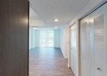 Located at 11855 SW 216th St in Miami, FL, this single-floor residence offers a thoughtfully designed layout with modern finishes and a clean, contemporary aesthetic throughout. The kitchen is a standout feature, equipped with stainless steel appliances including a refrigerator, range, microwave, and dishwasher, complemented by rich dark wood cabinetry, granite-style countertops, and a stainless steel sink. Light wood-style flooring flows consistently throughout the main living areas and bedrooms, lending the space a cohesive, polished look. The living area opens to a sliding glass door dressed with vertical blinds, allowing abundant natural light and outdoor views of the surrounding Miami landscape. A ceiling fan adds comfort to this bright, airy space. The bedrooms are generously proportioned, each featuring windows with horizontal blinds that frame scenic outdoor views, ceiling fans, and closet storage. One bedroom includes a walk-in closet with built-in racking, alongside a second closet and direct access to a bathroom. The bathrooms are finished with tile flooring, granite-topped dark wood vanities, large mirrors, and a shower-tub combination with clean white tile surrounds. The overall ambiance is bright, modern, and move-in ready.