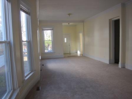 The view of the family room from as seen from the dining area. Front entry can be seen beyond. - 1435 South Center Street