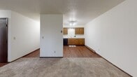 Located at 1112 Westrac Dr in Fargo, North Dakota, this single-floor unit offers a practical and functional layout suited for comfortable everyday living. The living area is spacious and features wall-to-wall carpeting, a textured ceiling, and a large window dressed with vertical blinds that allows natural light to fill the room. A wall-mounted air conditioning unit provides climate control, and baseboard heating runs along the perimeter for warmth during colder months.

The kitchen is well-appointed with warm wood cabinetry spanning both upper and lower sections, offering generous storage space. It includes a double-basin sink, white electric range, refrigerator, and a black dishwasher, all set against light countertops and hardwood-style flooring that adds a classic touch.

The bedrooms are carpeted and bright, each featuring windows with vertical blinds that invite natural light. The rooms offer clean, neutral walls and baseboard heating, creating a comfortable and adaptable environment.

The bathroom includes a vanity with a marble-patterned countertop, wood cabinetry below, a tub and shower combination with tiled walls, and hardwood-style flooring. The textured ceilings are consistent throughout the unit, contributing to a cohesive and understated aesthetic across the entire space.