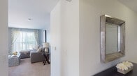 Located at 150 Erford Rd in Camp Hill, Pennsylvania, this single-floor residence offers a well-designed layout with a cohesive, neutral color palette and carpeted flooring throughout the living and sleeping areas. The open living room is finished in soft gray tones, featuring a sliding glass door that fills the space with natural light and provides access to an outdoor balcony. The kitchen is equipped with rich cherry wood cabinetry, granite countertops, stainless steel appliances including a refrigerator, range, and microwave, and light tile flooring that extends throughout. Adjacent to the kitchen, a dining area provides additional functionality. The primary bedroom is spacious and bright, with large windows that invite natural light and offer outdoor views. A second bedroom, styled as a dedicated home office, features a bold accent wall and a window overlooking the exterior. Both bathrooms are finished with granite-topped vanities, rich wood cabinetry, tile flooring, and tub-shower combinations. The entry hallway connects the spaces with a clean, open flow, complemented by a decorative mirror accent. Overall, the residence presents a comfortable and functional living environment with consistent, modern finishes throughout.
