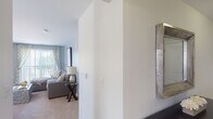 Located at 150 Erford Rd in Camp Hill, Pennsylvania, this single-floor residence offers a well-designed layout with a cohesive, neutral color palette and carpeted flooring throughout the living and sleeping areas. The open living room is finished in soft gray tones, featuring a sliding glass door that fills the space with natural light and provides access to an outdoor balcony. The kitchen is equipped with rich cherry wood cabinetry, granite countertops, stainless steel appliances including a refrigerator, range, and microwave, and light tile flooring that extends throughout. Adjacent to the kitchen, a dining area provides additional functionality. The primary bedroom is spacious and bright, with large windows that invite natural light and offer outdoor views. A second bedroom, styled as a dedicated home office, features a bold accent wall and a window overlooking the exterior. Both bathrooms are finished with granite-topped vanities, rich wood cabinetry, tile flooring, and tub-shower combinations. The entry hallway connects the spaces with a clean, open flow, complemented by a decorative mirror accent. Overall, the residence presents a comfortable and functional living environment with consistent, modern finishes throughout.