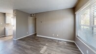 Located at 1345 S Kolb Rd in Tucson, Arizona, this one-bedroom, one-bathroom unit offers a practical and well-organized single-floor layout. The open living area greets you upon entry, featuring durable wood-look vinyl flooring, neutral taupe walls, a textured ceiling, and a distinctive vertical-panel accent wall that adds subtle character. Natural light filters in through blinded windows, brightening the space throughout the day.

The galley-style kitchen is efficiently designed with clean white cabinetry, light quartz-style countertops, a stainless steel sink, a gas range, and a refrigerator — providing all essential cooking amenities in a compact, functional footprint. Light-toned vinyl flooring keeps the kitchen feeling bright and easy to maintain.

The bedroom offers a comfortable and quiet retreat, finished with plush carpeting, neutral walls, a window with outdoor views, and direct access to a dedicated closet. The textured ceiling is consistent throughout the unit, giving a cohesive feel.

The bathroom is clean and straightforward, featuring a full tub-shower combination with chrome fixtures and wood-look flooring. Overall, this unit provides a functional, move-in-ready living environment well-suited for those seeking an efficient and low-maintenance space in Tucson.