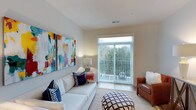 The Kirkpatrick floor plan is a thoughtfully designed 1-bedroom, 1-bathroom residence that maximizes comfort and functionality across a single level. The living area serves as the heart of the home, featuring neutral-toned walls that create a warm and versatile backdrop for any décor style. Large sliding glass doors flood the space with abundant natural light and open directly onto a private balcony, offering pleasant outdoor views of lush greenery. The living room provides ample space for comfortable seating arrangements and is complemented by smooth ceilings with standard ceiling height and hard-surface flooring that adds a clean, modern aesthetic. The kitchen and dining areas are designed for everyday convenience, flowing naturally from the main living space. The bedroom offers a private retreat with generous proportions, while the bathroom is well-appointed to meet daily needs. Throughout the residence, the layout emphasizes an open, airy feel, making the space feel inviting and efficient. The combination of natural light, private outdoor access, and a cohesive neutral palette gives the Kirkpatrick a bright, contemporary character suited for comfortable everyday living.