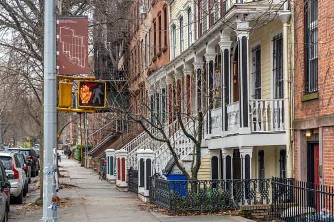 A sidewalk extends past a row of historic homes in the Fort Greene neighborhood.
