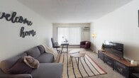 Located at 2525 Williams Dr in Burnsville, Minnesota, this single-floor residence offers a well-organized layout designed for comfortable everyday living. The carpeted living room serves as the central gathering space, featuring a large window with vertical blinds that allows natural light to fill the room, along with a wall-mounted air conditioning unit. The open feel of the space is complemented by a textured ceiling throughout.

The galley-style kitchen is efficiently designed with dark cabinetry lining both sides, light countertops, wood-look flooring, a gas range, refrigerator, and dishwasher — providing ample storage and functionality. Adjacent to the kitchen, the dining area features wood-look flooring, a ceiling fan with a light fixture, and enough space to comfortably seat a small group.

The residence includes two bedrooms, both carpeted and equipped with windows that bring in natural light and views of the surrounding neighborhood. Each bedroom offers a quiet, private retreat with baseboard heating. The bathroom includes a wide vanity with a white countertop, a large mirror, and bright overhead lighting.

Overall, the space presents a practical and cozy floor plan well-suited for residents seeking a functional home in the Burnsville community.
