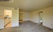 Located at 51 Grafton Avenue in Dayton, Ohio, this single-floor residence offers a straightforward and functional layout designed for comfortable everyday living. The interior is finished with wall-to-wall carpeting that adds warmth underfoot throughout the main living areas. The neutral color palette — featuring soft white walls and matching trim — creates a bright, clean atmosphere that provides a versatile backdrop for a variety of furnishing styles. Ceiling-mounted HVAC vents indicate a central air and heating system for year-round climate control. The space features multiple doorways leading to distinct areas of the home, supporting a well-organized floor plan. Closet storage is a notable feature, with louvered bi-fold closet doors providing practical and accessible storage solutions. Additional doors throughout the space suggest separate rooms offering privacy and defined functional zones. The smooth, paneled ceiling contributes to the tidy, well-maintained appearance of the interior. Overall, the residence presents a clean and move-in ready environment, with a modest and efficient design that prioritizes utility and livability within its single-story footprint.
