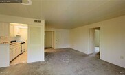 Located at 51 Grafton Avenue in Dayton, Ohio, this single-floor residence offers a straightforward and functional layout designed for comfortable everyday living. The interior is finished with wall-to-wall carpeting that adds warmth underfoot throughout the main living areas. The neutral color palette — featuring soft white walls and matching trim — creates a bright, clean atmosphere that provides a versatile backdrop for a variety of furnishing styles. Ceiling-mounted HVAC vents indicate a central air and heating system for year-round climate control. The space features multiple doorways leading to distinct areas of the home, supporting a well-organized floor plan. Closet storage is a notable feature, with louvered bi-fold closet doors providing practical and accessible storage solutions. Additional doors throughout the space suggest separate rooms offering privacy and defined functional zones. The smooth, paneled ceiling contributes to the tidy, well-maintained appearance of the interior. Overall, the residence presents a clean and move-in ready environment, with a modest and efficient design that prioritizes utility and livability within its single-story footprint.