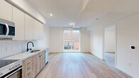 Located at 738 S Normandie Ave in Los Angeles, this thoughtfully designed one-bedroom, one-bathroom unit offers a modern and efficient living experience. The open-concept kitchen and living area is anchored by light wood flooring that flows seamlessly throughout the space, creating a warm and cohesive aesthetic. A large window fills the living area with natural light and provides views of the surrounding neighborhood.

The kitchen is well-appointed with stainless steel appliances, including a refrigerator, range with oven, and built-in microwave. Warm wood-toned lower cabinetry is paired with crisp white upper cabinets and a herringbone-patterned tile backsplash, offering both style and functionality. A stainless steel sink completes the workspace.

The bedroom is a calm, bright retreat with clean white walls, light wood flooring, and a built-in closet with sliding doors. The unit also includes a dedicated laundry area for added convenience.

The bathroom features a classic yet contemporary design with a black-and-white hexagonal tile floor, marble-style tiled tub surround, a bathtub-shower combo with matte black fixtures, and recessed lighting. Throughout the unit, recessed lighting and a clean white palette contribute to a bright, modern ambiance suited for urban living in the heart of Los Angeles.