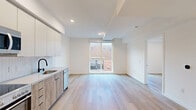Located at 738 S Normandie Ave in Los Angeles, this thoughtfully designed one-bedroom, one-bathroom unit offers a modern and efficient living experience. The open-concept kitchen and living area is anchored by light wood flooring that flows seamlessly throughout the space, creating a warm and cohesive aesthetic. A large window fills the living area with natural light and provides views of the surrounding neighborhood.

The kitchen is well-appointed with stainless steel appliances, including a refrigerator, range with oven, and built-in microwave. Warm wood-toned lower cabinetry is paired with crisp white upper cabinets and a herringbone-patterned tile backsplash, offering both style and functionality. A stainless steel sink completes the workspace.

The bedroom is a calm, bright retreat with clean white walls, light wood flooring, and a built-in closet with sliding doors. The unit also includes a dedicated laundry area for added convenience.

The bathroom features a classic yet contemporary design with a black-and-white hexagonal tile floor, marble-style tiled tub surround, a bathtub-shower combo with matte black fixtures, and recessed lighting. Throughout the unit, recessed lighting and a clean white palette contribute to a bright, modern ambiance suited for urban living in the heart of Los Angeles.
