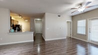 Located in San Antonio, TX, this well-appointed 3-bedroom, 2-bathroom residence offers a thoughtfully designed single-floor layout with a clean, neutral aesthetic throughout. The open-concept living and dining area features rich wood-style flooring, a ceiling fan, and seamless flow to the kitchen — ideal for both everyday living and entertaining. The kitchen is outfitted with dark espresso cabinetry, granite countertops, a breakfast bar peninsula, track lighting, and a full suite of black appliances including a refrigerator with ice maker, range, and microwave. A pantry provides additional storage convenience. The hallway leads to three bedrooms, each carpeted for comfort. The primary bedroom offers a walk-in closet with built-in shelving, while the secondary bedrooms feature individual closets and windows with blinds that bring in natural light. The bathrooms are finished with granite-topped dark vanities and wood-style flooring. Additional features include a dedicated laundry area, five closets for ample storage, a balcony for outdoor access, and a well-connected hallway layout. The overall ambiance is modern and move-in ready, with consistent finishes that create a cohesive, comfortable living environment.