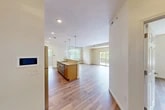 Located at 7592–7594 Buckley Rd in Syracuse, NY, this single-floor residence offers a thoughtfully designed layout that maximizes comfort and functionality. The open-concept kitchen and living area serves as the heart of the home, bathed in natural light from multiple windows and a set of sliding glass doors that lead to a private balcony overlooking lush, mature trees. The kitchen is outfitted with light maple cabinetry, granite countertops, a full suite of stainless steel appliances, and a glass tile backsplash. A large central island with pendant lighting provides additional prep space and casual seating, flowing seamlessly into the expansive living area with its warm hardwood-style flooring. The spacious bedroom features neutral tones, hardwood-style flooring, and two closets offering ample storage. Throughout the residence, recessed lighting and a textured ceiling add architectural interest, while the clean, neutral color palette creates a bright and airy ambiance. Two additional closets provide convenient storage solutions. The private balcony offers serene outdoor views of surrounding greenery, completing this well-rounded and move-in-ready residence.