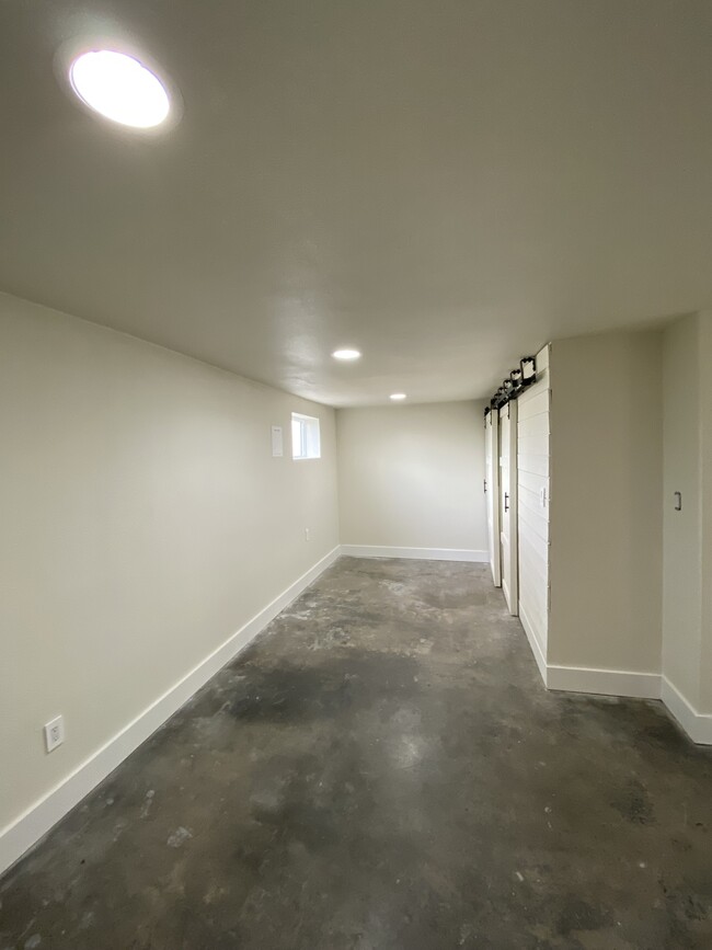 “Recreation Room” in floor plan; utility closet inside barn doors - 214 Naval Ave