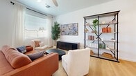 Located at 2627 N 83rd Ave in Phoenix, AZ, this two-story home offers 2 bedrooms, 3 bathrooms, and a thoughtfully designed layout spread across two floors. The main level features an open-concept kitchen and living room bathed in natural light. The kitchen is outfitted with crisp white shaker cabinetry, stainless steel appliances, quartz countertops, and light hardwood flooring that flows seamlessly into the living area, where a ceiling fan and curated shelving add warmth and functionality. A half bathroom on the main floor provides added convenience for guests. Upstairs, the generously sized primary bedroom features vaulted ceilings, a ceiling fan, plush carpeting, and multiple windows that fill the room with natural light. The spacious walk-in closet includes built-in shelving, hanging rods, and a cozy bench seat. A second well-appointed bedroom with its own walk-in closet and ceiling fan offers comfortable accommodations. A dedicated office space with stylish built-in shelving provides an ideal work-from-home setup. The bathrooms maintain a clean, modern aesthetic with light hardwood flooring and contemporary fixtures. Outdoors, a private backyard with a lush green lawn completes this well-rounded Phoenix home.