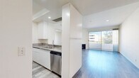 Located on Wilshire Boulevard in the heart of Los Angeles, this 2-bedroom, 3-bathroom residence offers a thoughtfully designed layout across a single floor. Light-toned hardwood-style flooring flows throughout, lending a clean, cohesive aesthetic to the entire space.

The kitchen is a standout feature, equipped with granite countertops, white cabinetry extending to the ceiling, and a full suite of stainless steel appliances including a gas range, built-in microwave, refrigerator, and dishwasher. A peninsula with a sink provides additional prep space and opens toward the living and dining areas.

The living room is bright and welcoming, anchored by a fireplace and floor-to-ceiling sliding glass doors that lead to a private balcony with outdoor views. A chandelier-lit dining area sits adjacent, completing the open entertaining space.

Both bedrooms are generously proportioned, filled with natural light from large windows. The spacious primary bedroom offers ample room and is supported by multiple closets throughout the unit — four in total. The three bathrooms are elegantly finished, with at least one featuring striking marble-look tile on both the floors and walls, a soaking tub, and a glass-enclosed shower.