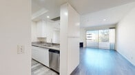 Located on Wilshire Boulevard in the heart of Los Angeles, this 2-bedroom, 3-bathroom residence offers a thoughtfully designed layout across a single floor. Light-toned hardwood-style flooring flows throughout, lending a clean, cohesive aesthetic to the entire space.

The kitchen is a standout feature, equipped with granite countertops, white cabinetry extending to the ceiling, and a full suite of stainless steel appliances including a gas range, built-in microwave, refrigerator, and dishwasher. A peninsula with a sink provides additional prep space and opens toward the living and dining areas.

The living room is bright and welcoming, anchored by a fireplace and floor-to-ceiling sliding glass doors that lead to a private balcony with outdoor views. A chandelier-lit dining area sits adjacent, completing the open entertaining space.

Both bedrooms are generously proportioned, filled with natural light from large windows. The spacious primary bedroom offers ample room and is supported by multiple closets throughout the unit — four in total. The three bathrooms are elegantly finished, with at least one featuring striking marble-look tile on both the floors and walls, a soaking tub, and a glass-enclosed shower.