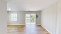 Located at 4592 Channing Terrace in Columbus, OH, this well-appointed one-bedroom, one-bathroom home offers a thoughtfully designed single-floor layout with a clean, modern aesthetic throughout. The open-concept kitchen and living area serves as the heart of the home, featuring light hardwood-style flooring that creates a warm, cohesive feel. The galley-style kitchen is outfitted with white shaker cabinets accented by matte black hardware, granite-look countertops, a stainless steel sink with a matte black faucet, and stainless steel appliances including a refrigerator. Ample upper and lower cabinetry provides generous storage. The adjoining living room is bright and welcoming, highlighted by a sliding glass door with vertical blinds that opens to outdoor views, alongside a second window that draws in additional natural light. A distinctive vertical shiplap accent wall adds character to the living space. The bedroom offers plush wall-to-wall carpeting, two windows with views of the surrounding neighborhood, and a built-in closet for storage. The full bathroom features a combination tub and shower with a sleek white surround, a vanity with white cabinetry, and warm hardwood-style flooring, all finished with matte black fixtures for a cohesive, contemporary touch.