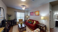 This 2-bedroom, 2-bathroom residence is thoughtfully designed across a single floor, offering a functional and cohesive layout. The open living area features warm wood-style flooring that flows throughout the space, complemented by neutral-toned walls and ceiling fans with light fixtures that provide both comfort and ambiance. Large windows dressed with curtains and blinds allow natural light to fill the room, creating an inviting atmosphere.

The kitchen is outfitted with dark espresso cabinetry, granite-style countertops, a double-basin stainless steel sink, and a pass-through breakfast bar that connects seamlessly to the living area — ideal for casual dining or entertaining.

Both bedrooms are comfortably sized, each featuring ceiling fans, windows with blinds and curtains, and wood-style flooring. The rooms offer a cozy, private retreat with ample wall space.

The two bathrooms are functionally appointed, each featuring a tub-shower combination, tile flooring, and clean, neutral finishes. Together, they provide convenient access for residents and guests alike.

Overall, the space presents a practical and comfortable single-floor layout with consistent finishes throughout, making it a well-rounded residential unit.