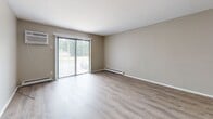 This 850 square foot apartment offers a well-designed living space with two bedrooms and three bathrooms. The single-floor layout maximizes efficiency, with the primary bedroom boasting a generous 140 square feet. Throughout the apartment, light-toned wood-look flooring creates a cohesive and modern aesthetic. Large windows in the living areas and bedrooms allow for abundant natural light, enhancing the sense of space. The living room features sliding glass doors, potentially leading to an outdoor area. All rooms are painted in neutral tones, providing a clean and versatile backdrop for various decor styles. The bathrooms are equipped with modern fixtures, including a bathtub in at least one. The kitchen, while not shown, likely continues the contemporary theme. Closet space is available, with at least one bedroom featuring a sliding closet door. Baseboard heating units are visible, ensuring comfort year-round. The apartment's design emphasizes functionality and contemporary style, ideal for those seeking a modern living space in Franklin, Wisconsin.