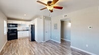 Located at 1515 Nunneley Pl in Wichita Falls, TX, this single-story 2-bedroom, 1-bathroom home offers a well-organized layout with consistent, updated finishes throughout. Wood-look laminate flooring runs through every room, lending a clean and cohesive feel to the entire space.

The kitchen is a standout feature, showcasing white shaker-style cabinetry with ample upper and lower storage, dark countertops, and a classic subway tile backsplash. Stainless steel appliances — including a refrigerator — complement the black range and built-in microwave, creating a functional and visually appealing cooking space.

The open living and dining area connects directly to the kitchen and features a ceiling fan with light fixture and neutral gray walls. Both bedrooms are comfortably sized, each equipped with ceiling fans and wood-look flooring. The primary bedroom includes two closets for added storage, while both rooms benefit from windows that bring in natural light.

The full bathroom is tiled floor to ceiling around the tub/shower combination, accented with a decorative mosaic border strip, providing a clean and polished look. A hallway connects the bedrooms and bathroom, keeping the layout efficient. The home also includes a utility panel and HVAC venting throughout for year-round comfort.