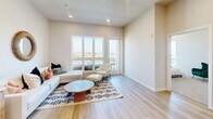 Located at 398 West Valley Boulevard in San Gabriel, CA, this thoughtfully designed one-bedroom, two-bathroom residence offers a clean, modern aesthetic throughout its single-floor layout. Light wood-style flooring flows seamlessly through the open-concept kitchen and living area, creating a bright and cohesive atmosphere. The kitchen is outfitted with warm wood-tone cabinetry, white quartz countertops, stainless steel appliances including a refrigerator, gas range, microwave, and dishwasher, providing a well-equipped space for cooking and entertaining. The adjacent living area is bathed in natural light and features access to an outdoor balcony with sweeping panoramic views of the surrounding San Gabriel Valley landscape. The generously sized primary bedroom is carpeted for comfort and benefits from multiple windows that frame picturesque outdoor views, filling the room with natural light. Two full bathrooms serve the residence; one features a soaking tub with clean white tile surround, while the other includes a tub-shower combination enclosed by a sliding glass door, paired with a wood-vanity and illuminated mirror. Neutral tones, recessed lighting, and clean finishes throughout contribute to a calm, contemporary ambiance.