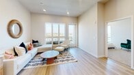 Located at 398 West Valley Boulevard in San Gabriel, CA, this thoughtfully designed one-bedroom, two-bathroom residence offers a clean, modern aesthetic throughout its single-floor layout. Light wood-style flooring flows seamlessly through the open-concept kitchen and living area, creating a bright and cohesive atmosphere. The kitchen is outfitted with warm wood-tone cabinetry, white quartz countertops, stainless steel appliances including a refrigerator, gas range, microwave, and dishwasher, providing a well-equipped space for cooking and entertaining. The adjacent living area is bathed in natural light and features access to an outdoor balcony with sweeping panoramic views of the surrounding San Gabriel Valley landscape. The generously sized primary bedroom is carpeted for comfort and benefits from multiple windows that frame picturesque outdoor views, filling the room with natural light. Two full bathrooms serve the residence; one features a soaking tub with clean white tile surround, while the other includes a tub-shower combination enclosed by a sliding glass door, paired with a wood-vanity and illuminated mirror. Neutral tones, recessed lighting, and clean finishes throughout contribute to a calm, contemporary ambiance.