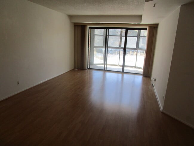 Living room, view of balcony - 2100 Langston Blvd