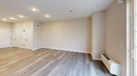 Located at 100 Blenheim Erial Rd in Blackwood, NJ, this well-appointed 2-bedroom, 3-bathroom residence offers a thoughtfully designed single-floor layout with a clean, contemporary aesthetic throughout. The open-concept kitchen and living area serves as the heart of the home, showcasing a large center island with a white quartz countertop and undermount sink, warm wood-tone cabinetry, a subway tile backsplash, and a full suite of stainless steel appliances including a gas range, microwave, and refrigerator. Light wood-look flooring flows through the living and kitchen areas, while recessed lighting and a sliding glass door opening to a private balcony fill the space with natural light. The spacious living room provides ample room to relax, with neutral walls and a clean, open feel. Both bedrooms are generously sized, featuring plush carpeting, large windows with blinds, and direct access to well-appointed bathrooms. The primary bedroom connects to a private en-suite bath with a wide vanity, wood cabinetry, and large-format tile flooring. Walk-in closets with built-in wire shelving provide excellent storage. The three bathrooms maintain a consistent, modern finish with neutral tile and wood-accented vanities, contributing to the home's cohesive and comfortable ambiance.